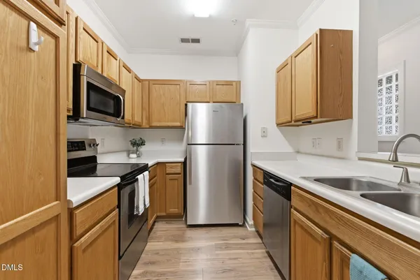 a kitchen with a refrigerator stove and sink