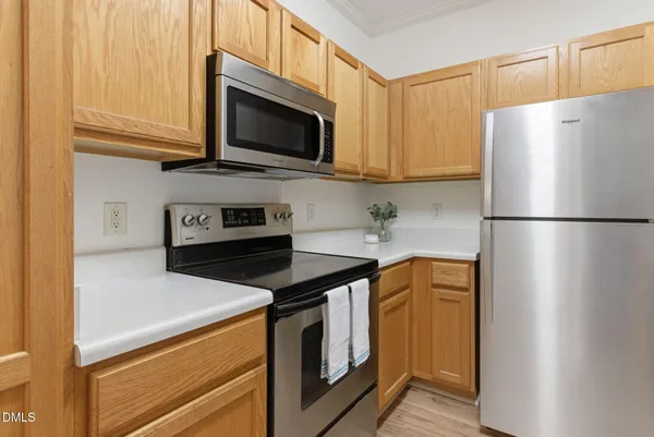a kitchen with stainless steel appliances a refrigerator stove and microwave