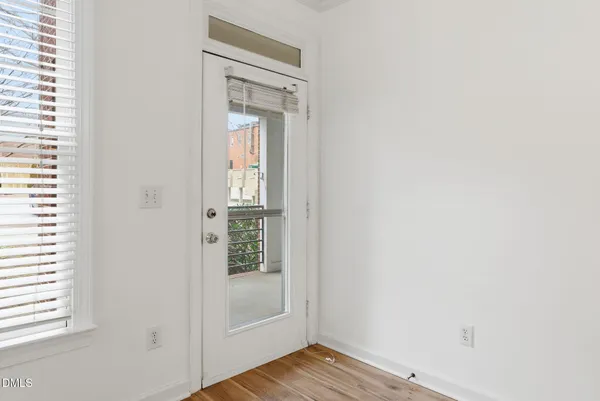a view of front door with wooden floor