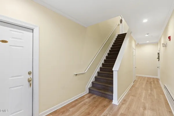 a view of a hallway with wooden floor and entryway