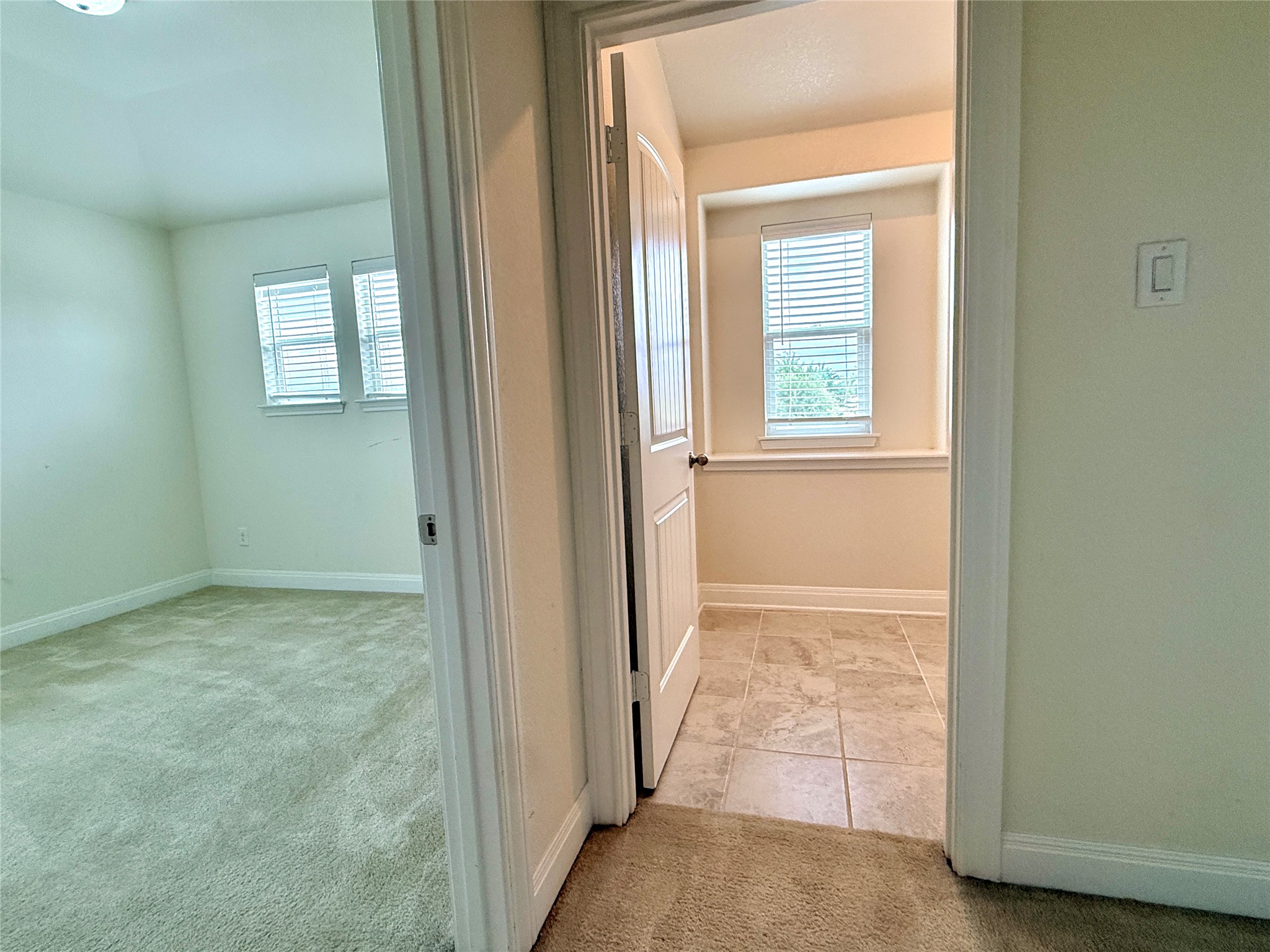 2101 Split Diamond Way, Unit 40 Round Rock, TX 78664 - Photo 27 of 32 Two distinct rooms seamlessly connect, one offering plush carpeting, the other durable tile.