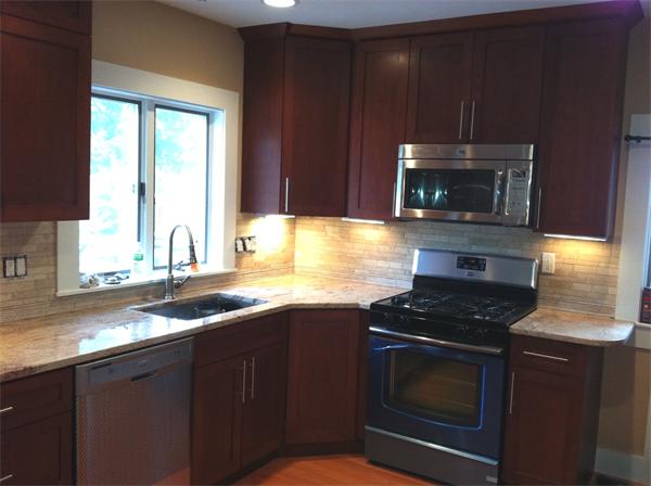 261 Marrett Road Lexington, MA 02421 - Photo 11 of 24 a kitchen with granite countertop a stove a microwave a sink and cabinets