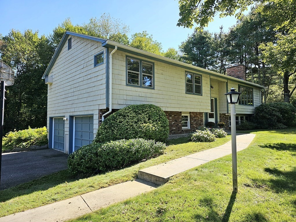a view of a house with backyard and sitting area