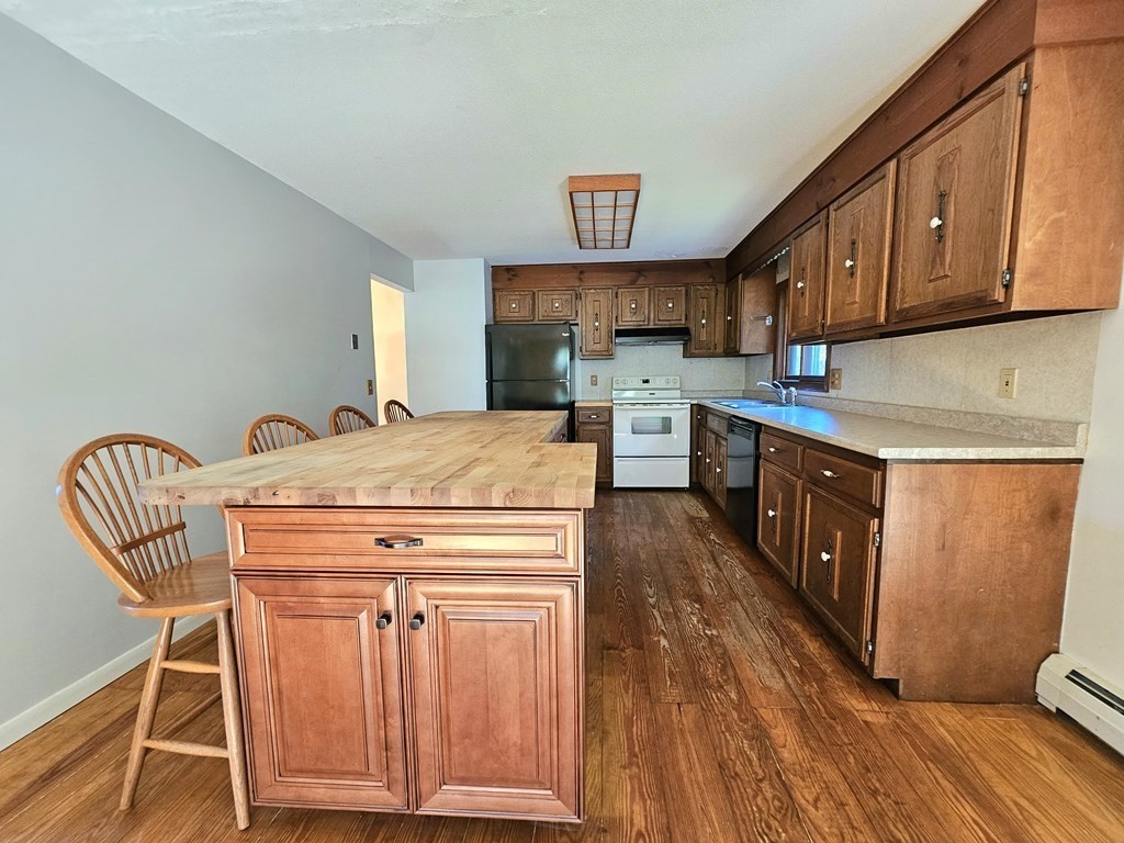 47 Stagecoach Road Amherst, MA 01002 - Photo 13 of 38 a kitchen with stainless steel appliances granite countertop a stove a sink dishwasher and cabinets with wooden floor