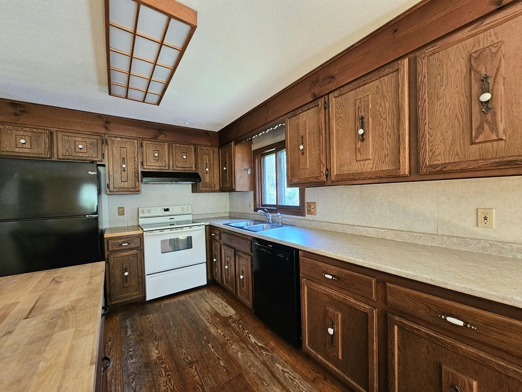 47 Stagecoach Road Amherst, MA 01002 - Photo 14 of 38 a kitchen with stainless steel appliances granite countertop a sink a stove and cabinets