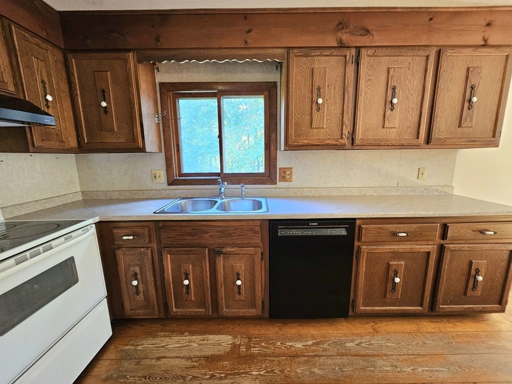 47 Stagecoach Road Amherst, MA 01002 - Photo 15 of 38 a kitchen with stainless steel appliances granite countertop a sink stove and cabinets