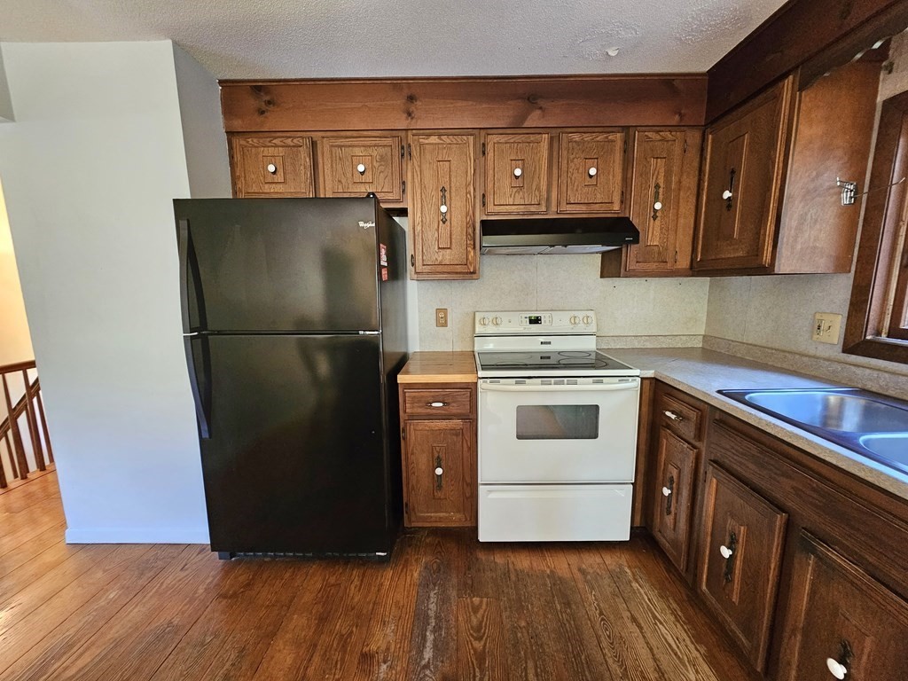 47 Stagecoach Road Amherst, MA 01002 - Photo 17 of 38 a kitchen with a refrigerator sink and cabinets