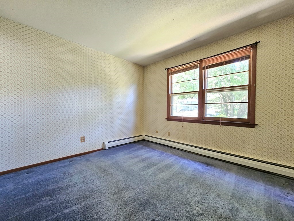 47 Stagecoach Road Amherst, MA 01002 - Photo 19 of 38 an empty room with wooden floor and windows
