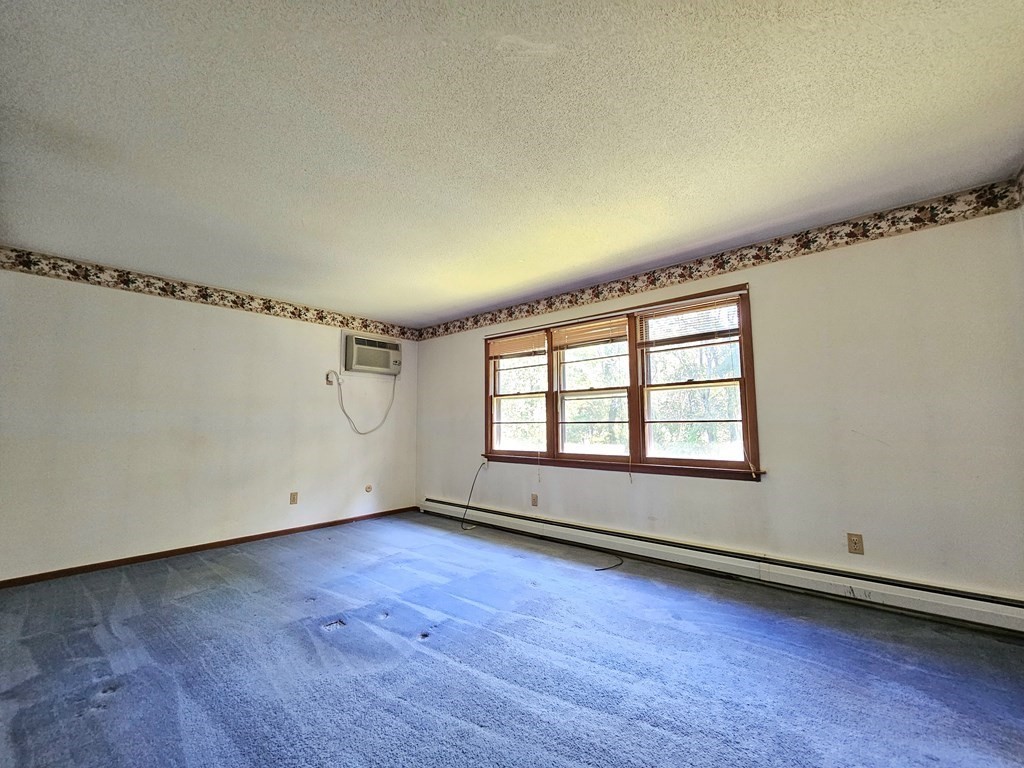 47 Stagecoach Road Amherst, MA 01002 - Photo 23 of 38 an empty room with wooden floor and windows