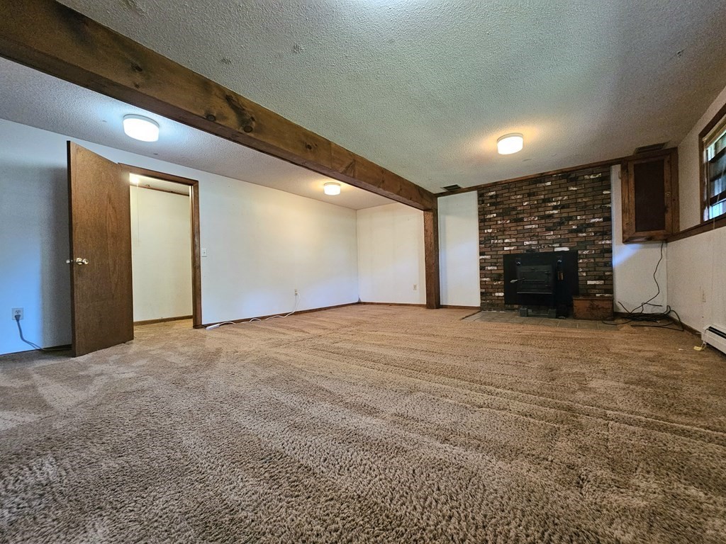 47 Stagecoach Road Amherst, MA 01002 - Photo 28 of 38 a view of an empty room with a fireplace