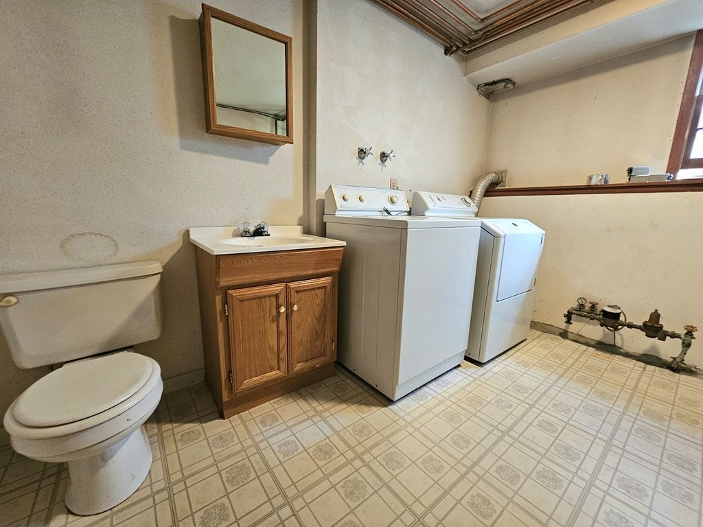 47 Stagecoach Road Amherst, MA 01002 - Photo 32 of 38 a bathroom with a sink a toilet and mirror