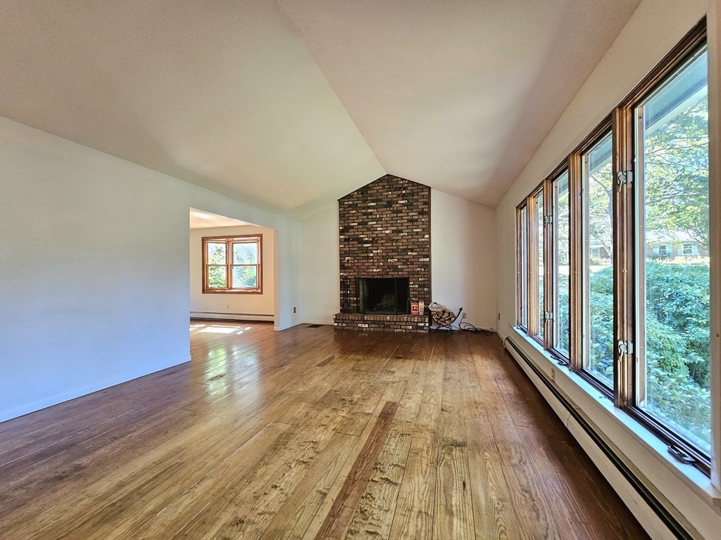47 Stagecoach Road Amherst, MA 01002 - Photo 5 of 38 a view of empty room with wooden floor and fireplace