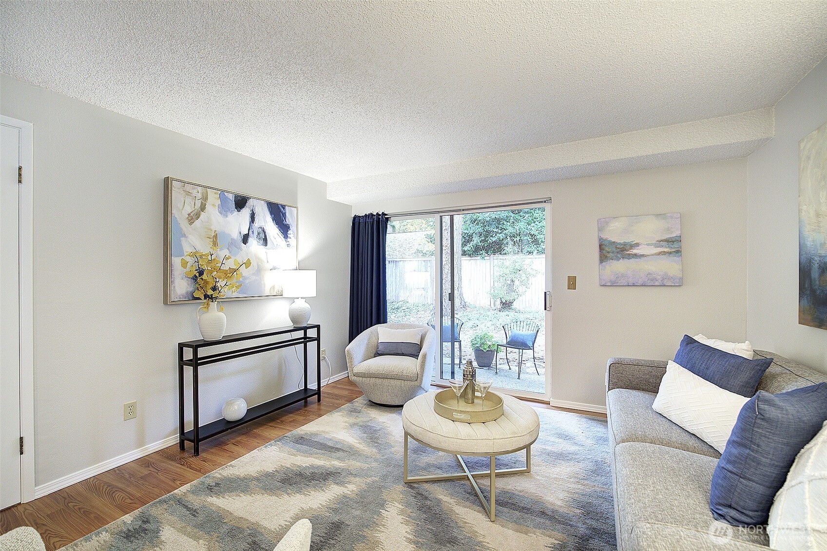 9900 Northeast 124th Street, Unit 1315 Kirkland, WA 98034 - Photo 6 of 20 a living room with furniture and a wooden floor