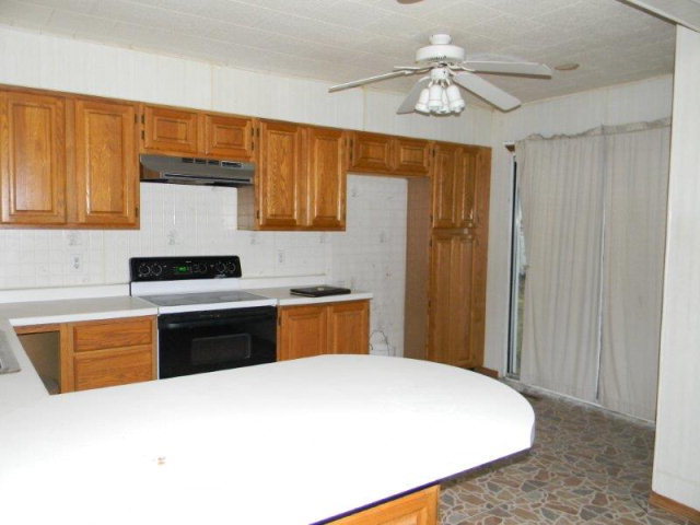 205 West Henry Street Odell, IL 60460 - Photo 2 of 10 a kitchen with stainless steel appliances granite countertop a stove a sink and a refrigerator