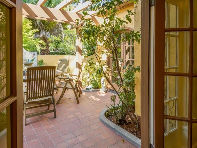 45 Clark Drive San Mateo, CA 94401 - Photo 8 of 49 a view of a porch with a bench and floor to ceiling window and potted plants