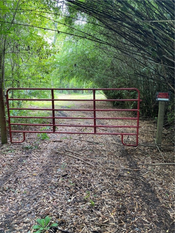 a view of a yard with wooden fence