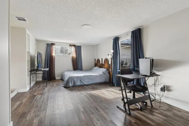 a bedroom with a bed and a table in it