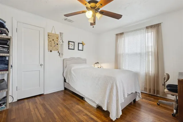 a spacious bedroom with a bed and a window
