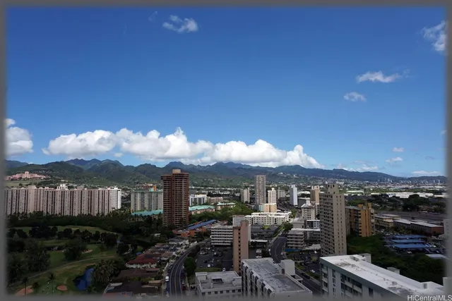 a front view of a multi story building with a yard