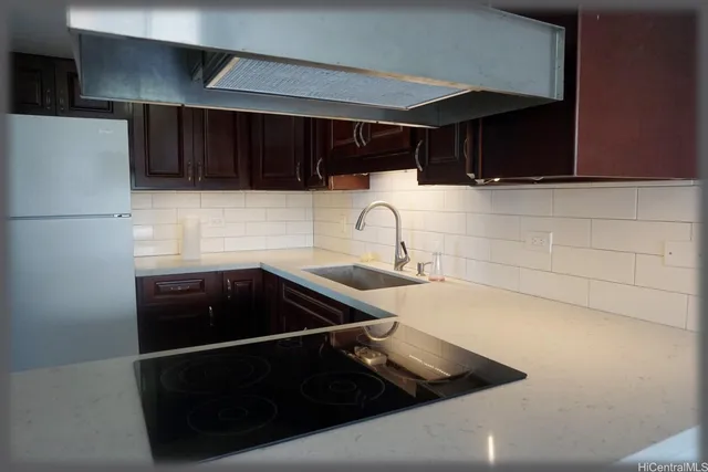 a kitchen with a sink and white cabinets