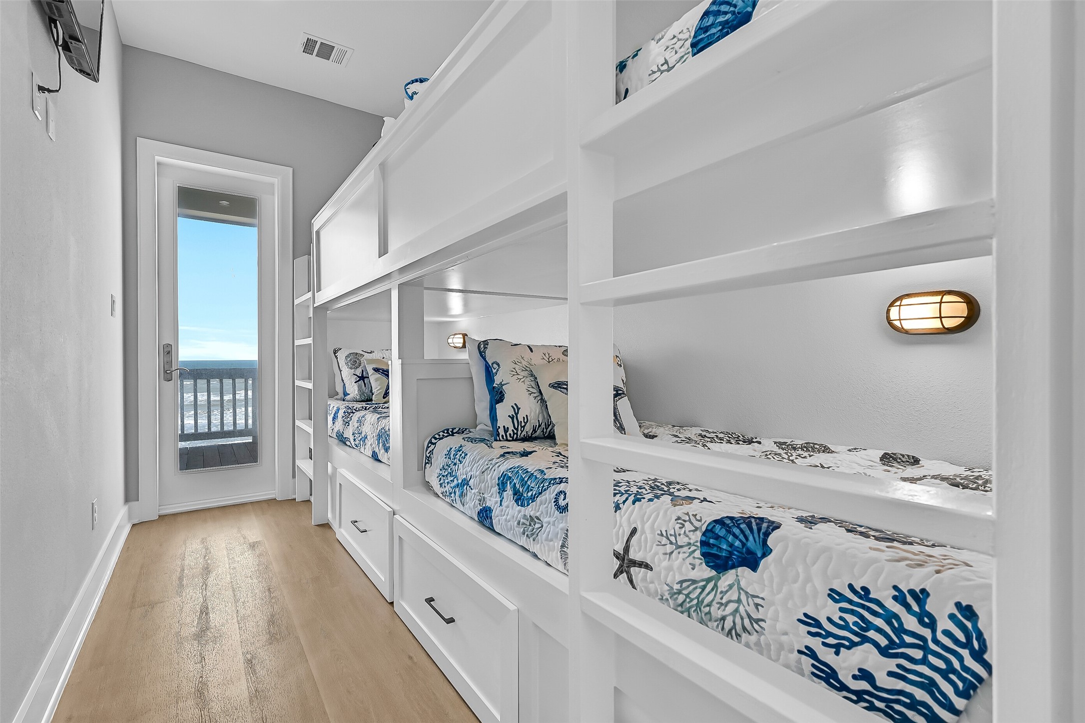 16728 West Beach Road Jamaica Beach, TX 77554 - Photo 29 of 46 As you head to the second level, the first room you’ll find is a bunk room featuring four built-in twin bunks and deck access.