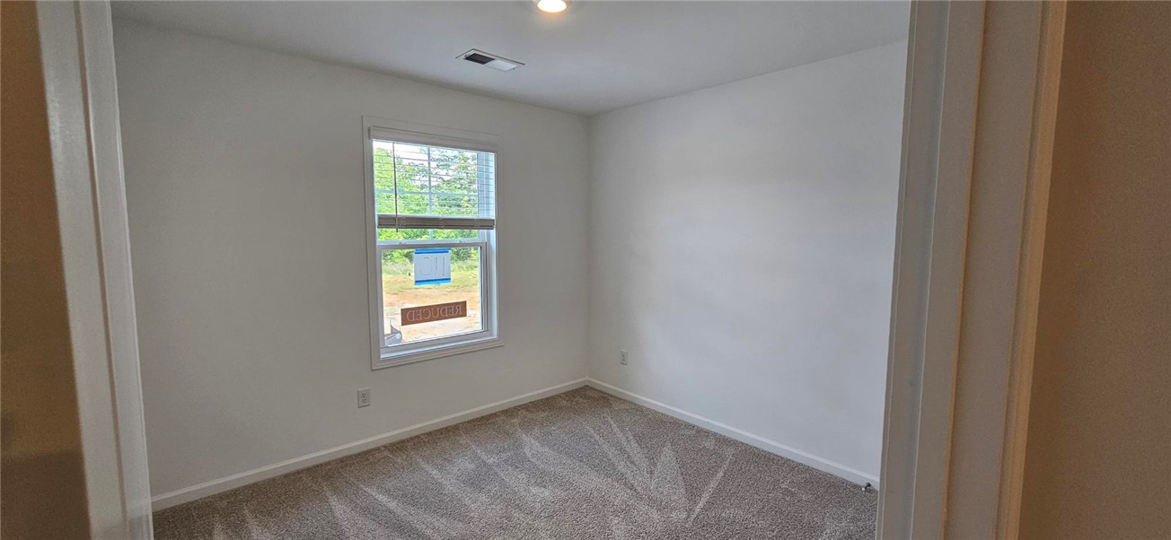 409 Belgrove Way Easley, SC 29640 - Photo 12 of 15 Bright and inviting bedroom with ample natural light, creating a serene personal retreat.