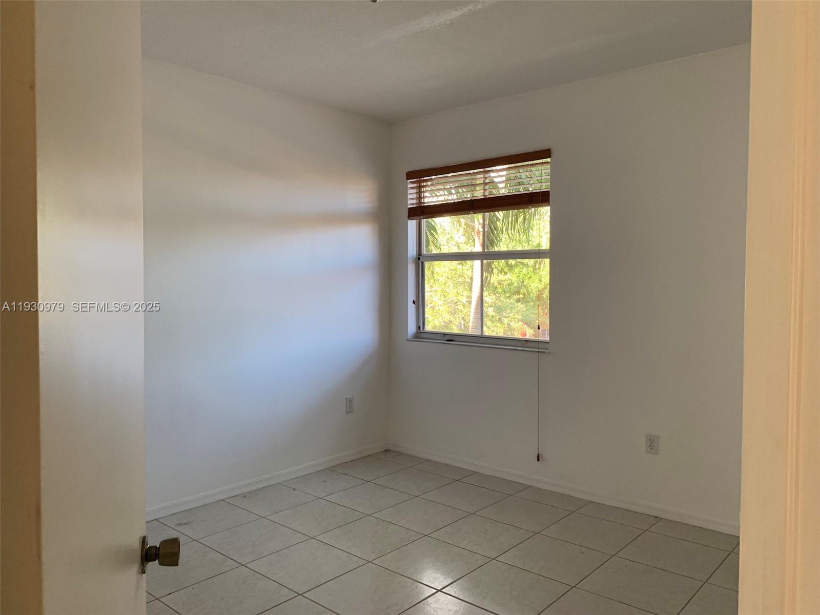 3150 Southwest 152nd Place, Unit 3150 Miami, FL 33185 - Photo 20 of 25 a view of an empty room with a window