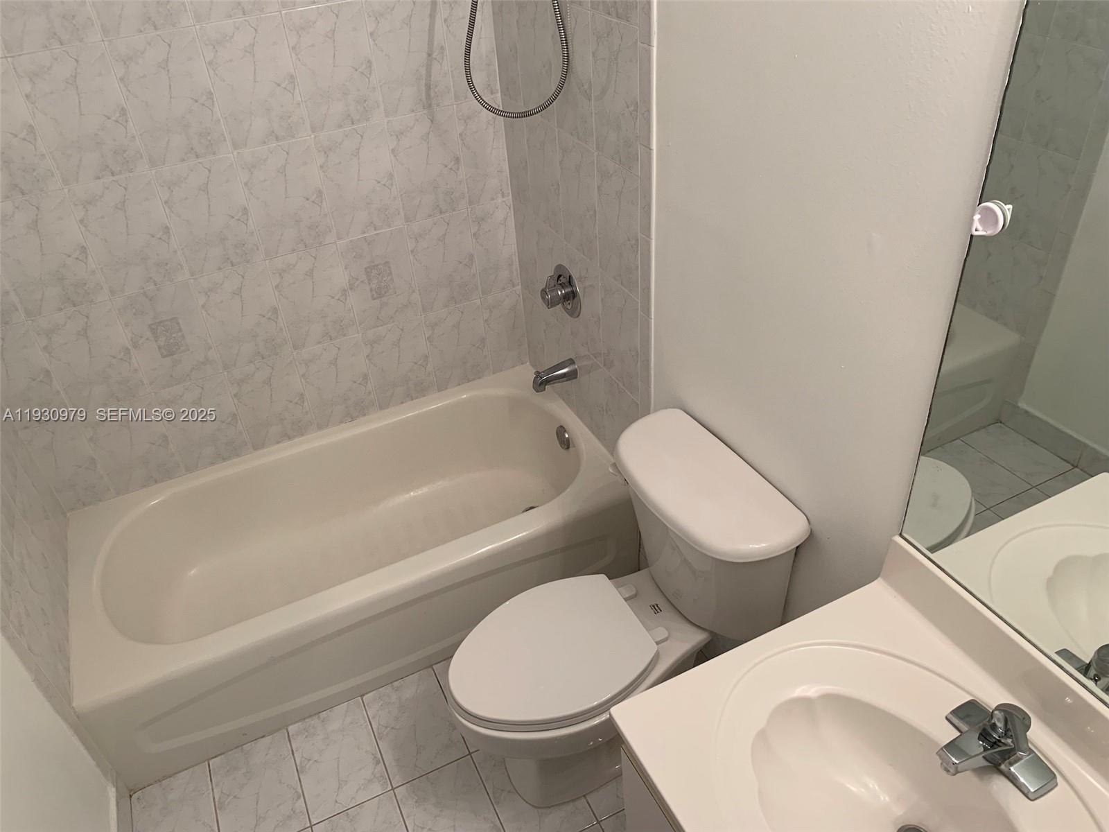 3150 Southwest 152nd Place, Unit 3150 Miami, FL 33185 - Photo 23 of 25 a bathroom with a toilet and a sink