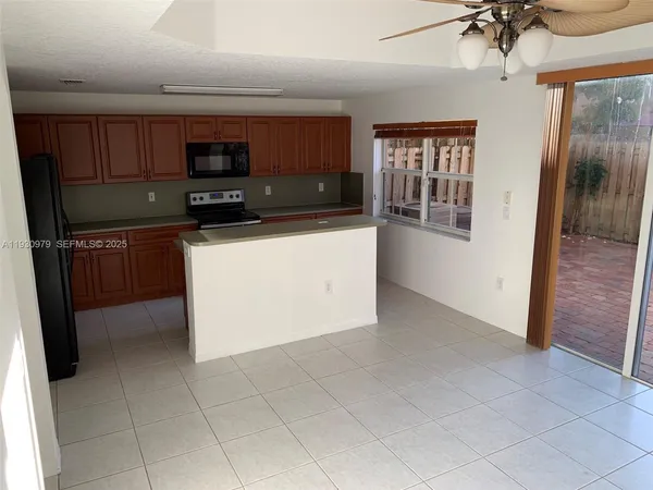 a kitchen with stainless steel appliances a refrigerator and a sink