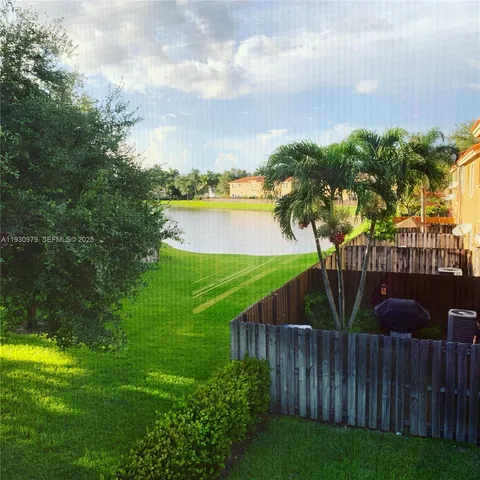 a kitchen with a sink a stove and a microwave