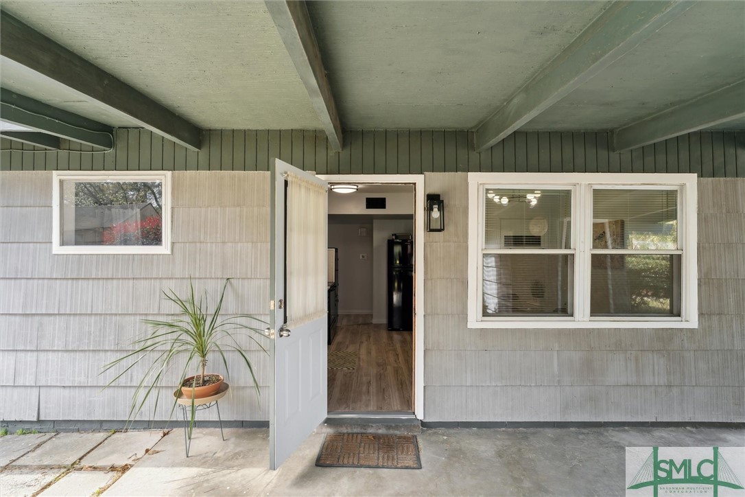 321 Woodley Road Savannah, GA 31419 - Photo 22 of 26 Exterior door leading from kitchen to carport.