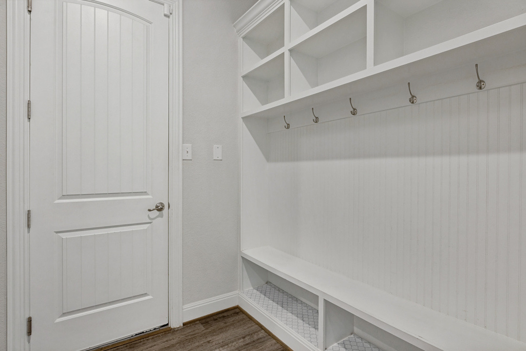 727 Spinnaker Loop Kyle, TX 78640 - Photo 26 of 29 Functional built-in shelving and a bench seat maximize storage space in this drop zone.