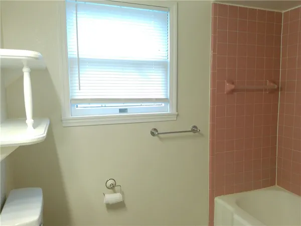 a bathroom with a window a toilet and a sink