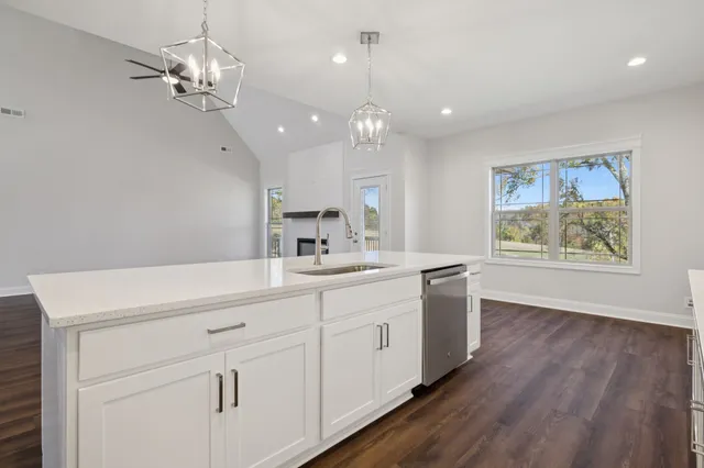 a view of empty room with wooden floor and ceiling fan