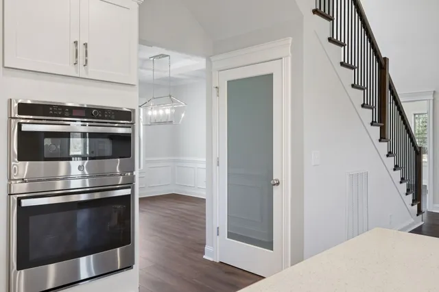 a bathroom with a granite countertop sink two mirror and shower