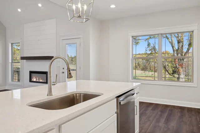 an empty room with a window and ceiling fan