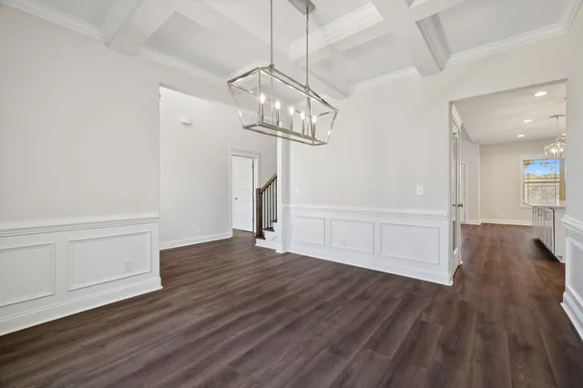 an empty room with a ceiling fan and windows