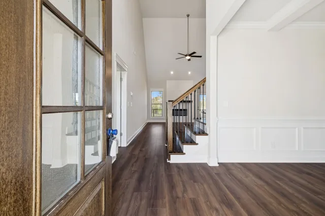 a view of empty room with wooden floor and fireplace