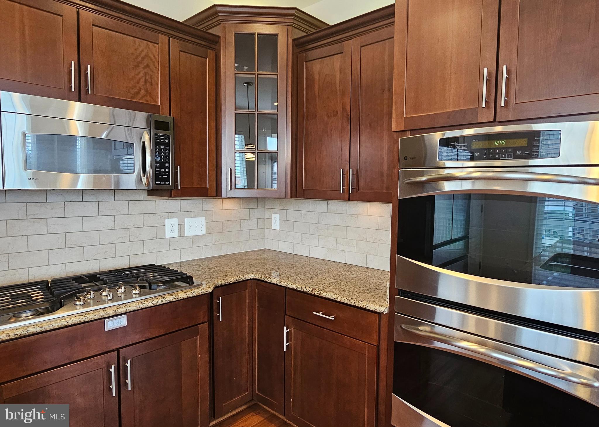 22629 Hawkbill Square Brambleton, VA 20148 - Photo 12 of 40 a kitchen with granite countertop stainless steel appliances and wooden cabinets