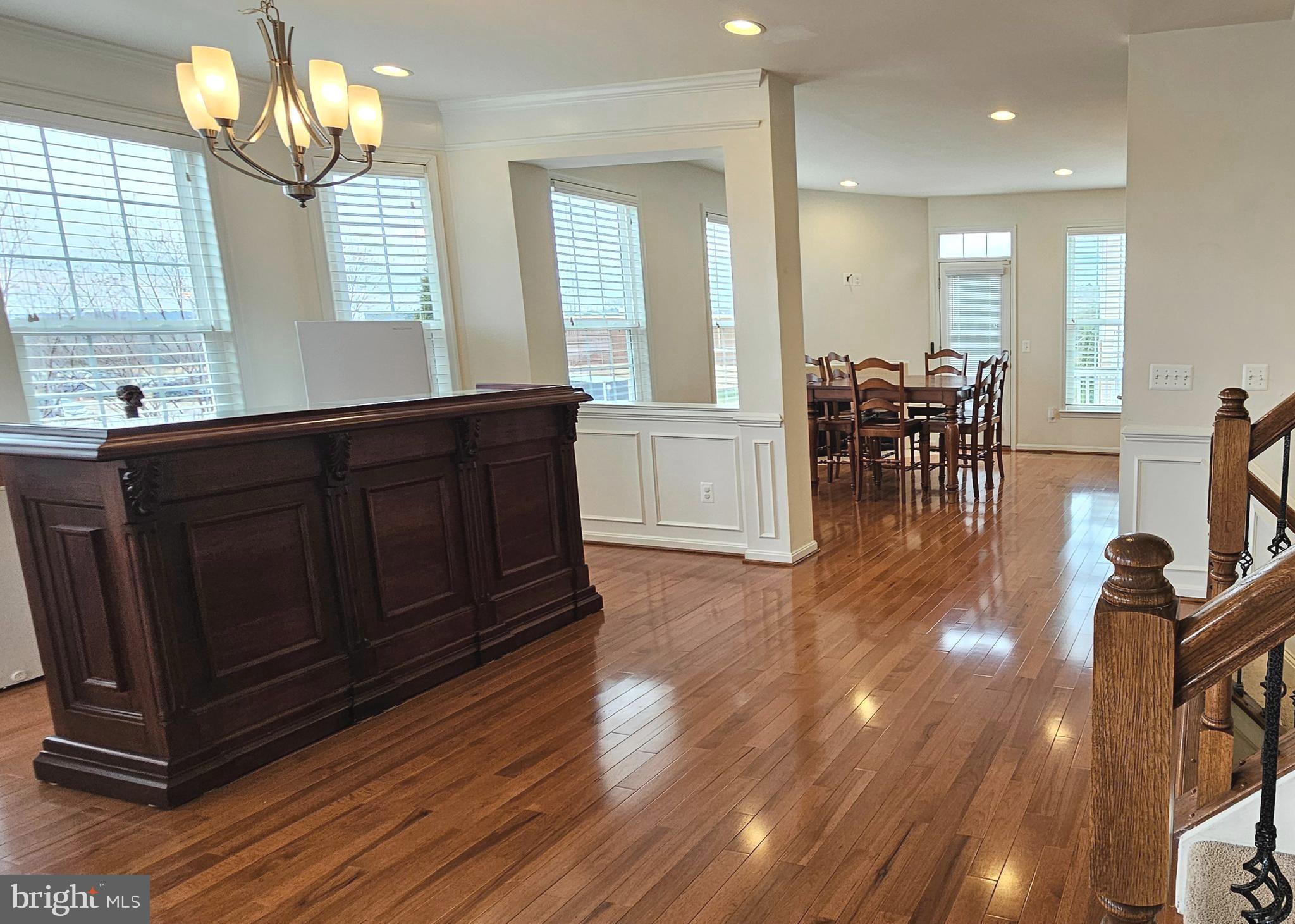 22629 Hawkbill Square Brambleton, VA 20148 - Photo 13 of 40 a kitchen with wooden floors and glass windows