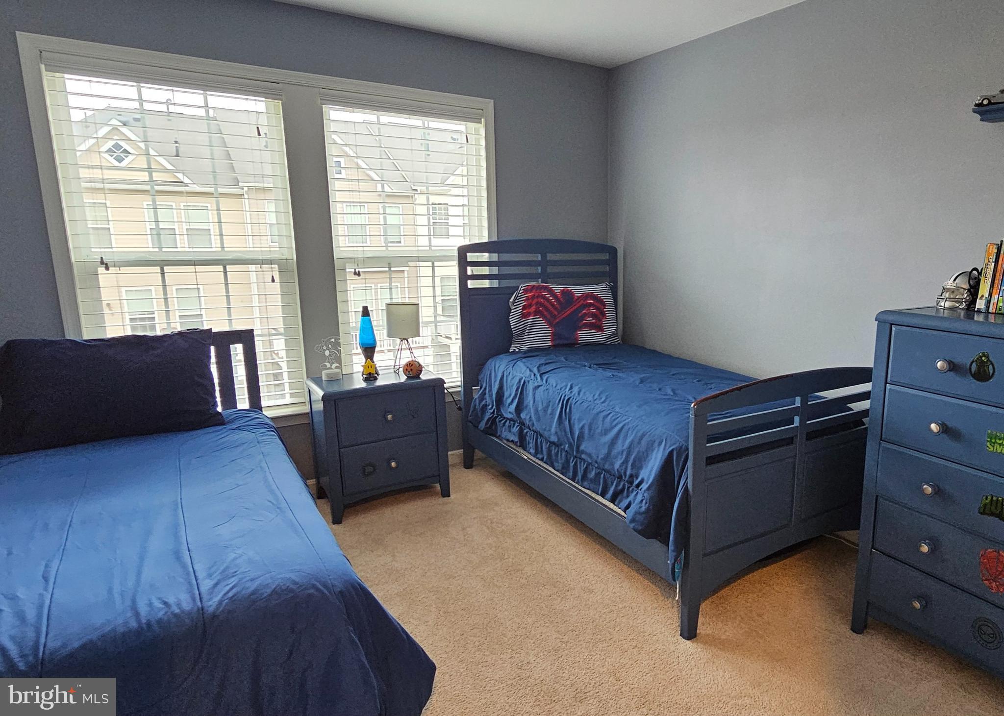 22629 Hawkbill Square Brambleton, VA 20148 - Photo 31 of 40 a bedroom with a bed and wooden floor