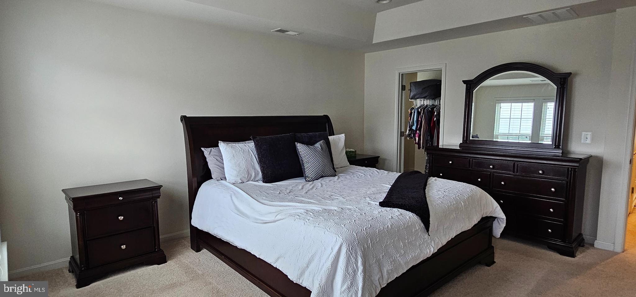 22629 Hawkbill Square Brambleton, VA 20148 - Photo 34 of 40 a bedroom with a bed and a closet with mirror