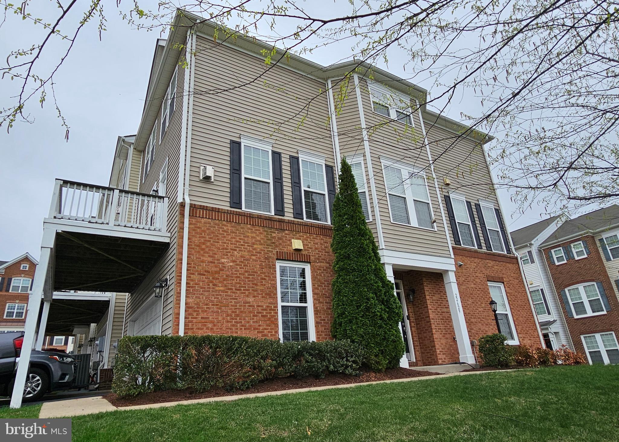 22629 Hawkbill Square Brambleton, VA 20148 - Photo 38 of 40 a front view of a house with a yard and trees