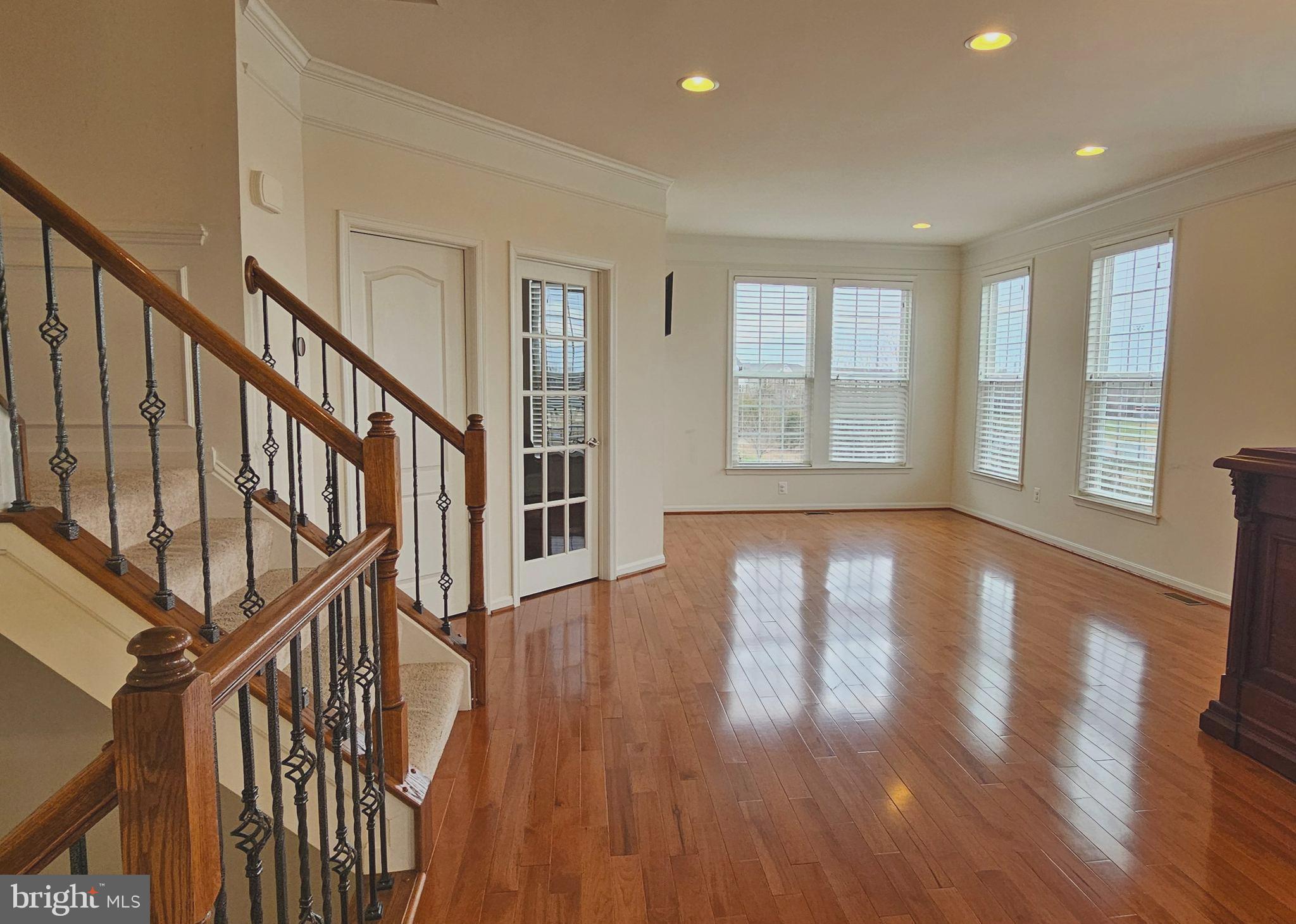 22629 Hawkbill Square Brambleton, VA 20148 - Photo 8 of 40 a view of an entryway with wooden floor and door