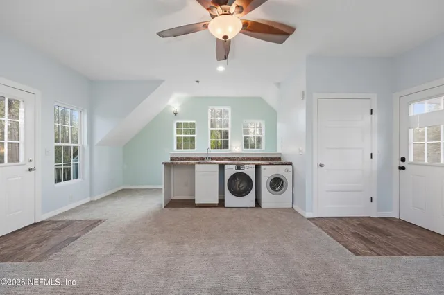 a view of a livingroom with a window and a fireplace