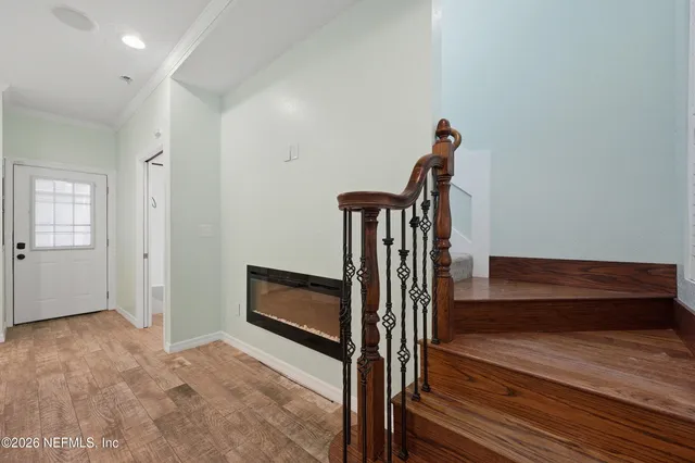 a view of entryway and hall with wooden floor
