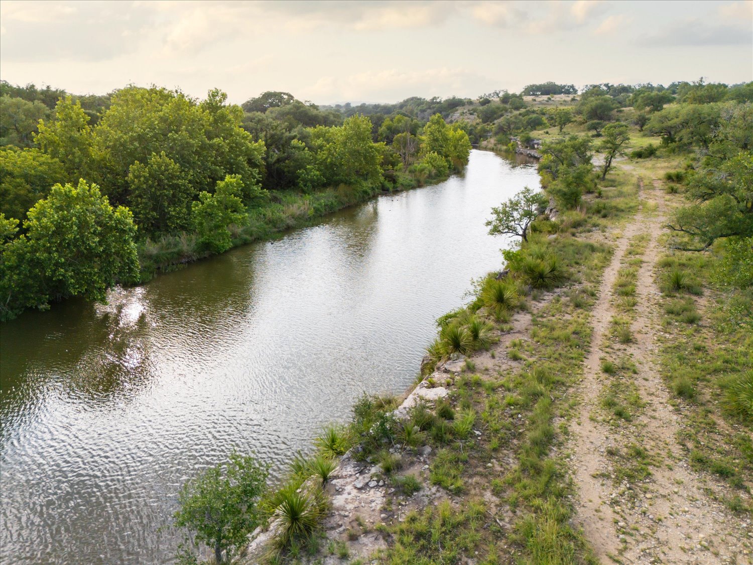 Lot 7 Byrd Ranch Road Johnson City, TX 78636 - Photo 21 of 25 a view of a lake with a mountain in the background