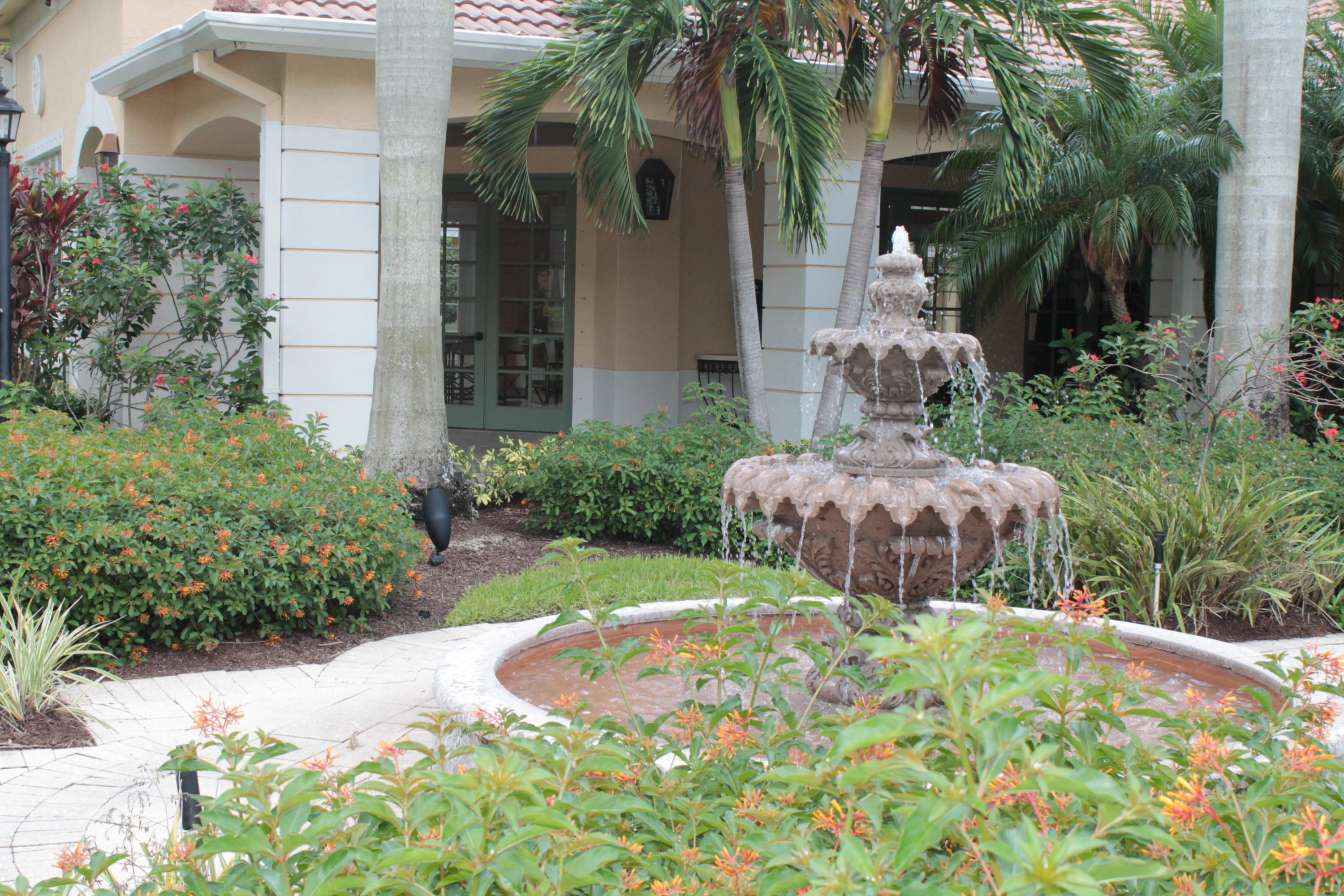 6682 West Sample Road, Unit 6682 Coral Springs, FL 33067 - Photo 7 of 9 a view of backyard with garden and tall trees