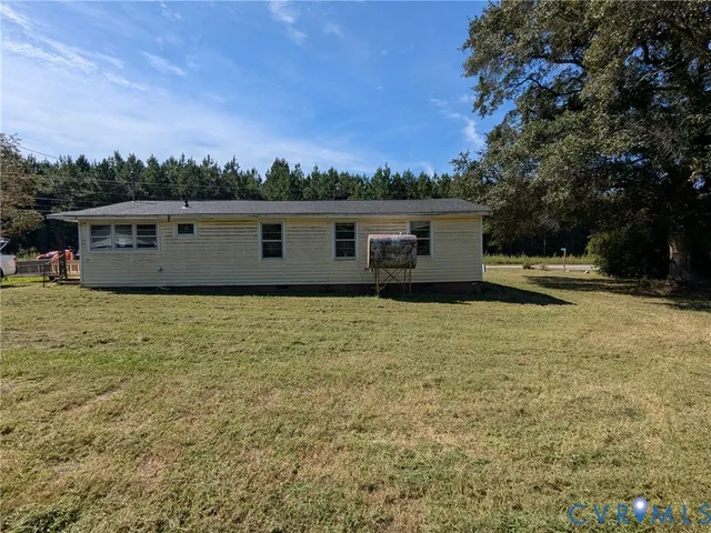 a backyard of a house with table and chairs