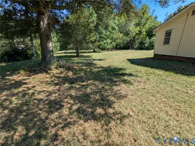 a big yard with lots of green space and trees